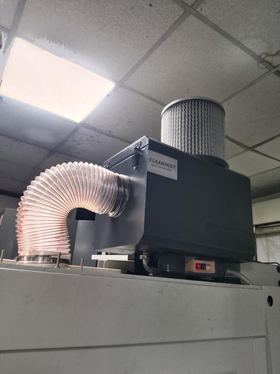 Cleanmist mist collector with flexible duct mounted on a CNC machine